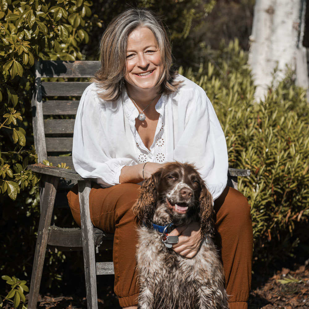 Dr Tonya Cruikshank relaxing outdoors with her pet dog